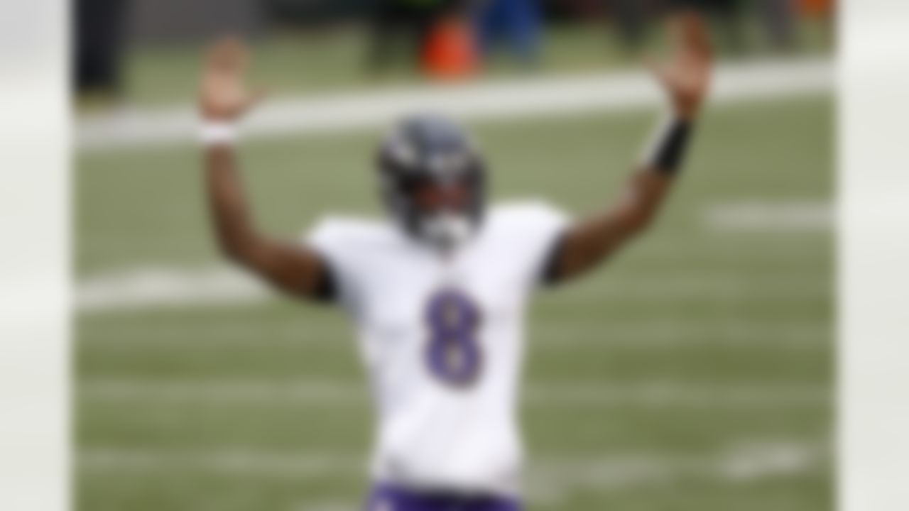 Baltimore Ravens quarterback Lamar Jackson (8) celebrates after running back J.K. Dobbins (27) ran in for a touchdown against the Cincinnati Bengals during the second half of an NFL football game, Sunday, Jan. 3, 2021, in Cincinnati.