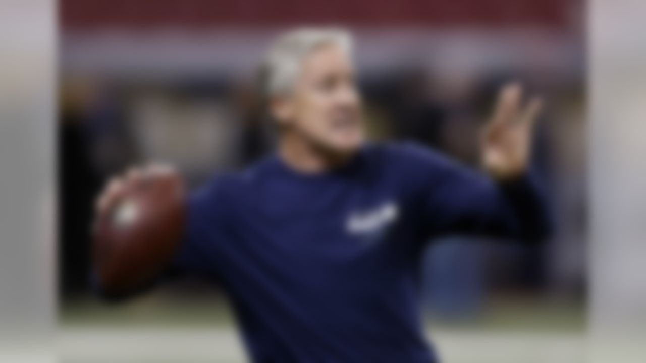 Seattle Seahawks head coach Pete Carroll throws a ball during the warmup before an NFL football game against the St. Louis Rams, Monday, Oct. 28, 2013, in St. Louis. (AP Photo/Michael Conroy)