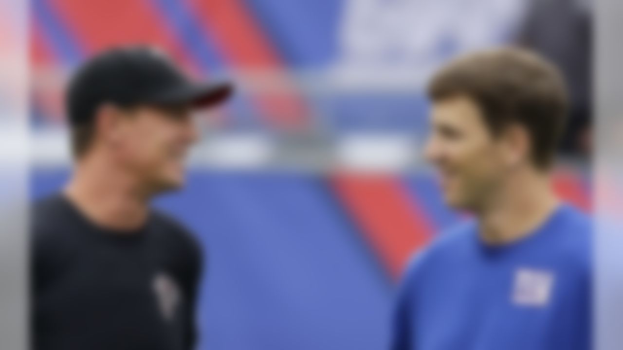 Atlanta Falcons quarterback Matt Ryan, left, and New York Giants quarterback Eli Manning talk prior to an NFL football game, Sunday, Sept. 20, 2015, in East Rutherford, N.J. (AP Photo/Seth Wenig)