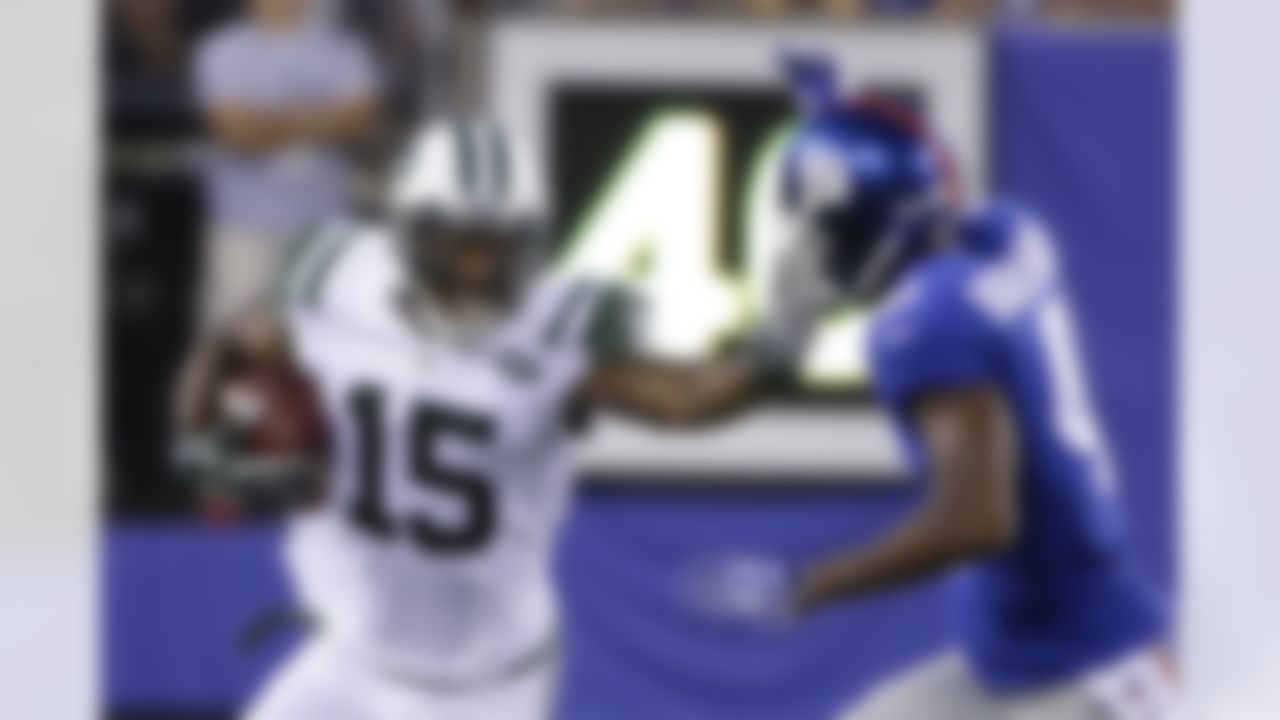 New York Jets wide receiver Brandon Marshall (15) stiff-arms New York Giants' Dominique Rodgers-Cromartie (41) during the first half of a preseason NFL football game Saturday, Aug. 29, 2015, in East Rutherford, N.J. (AP Photo/Seth Wenig)