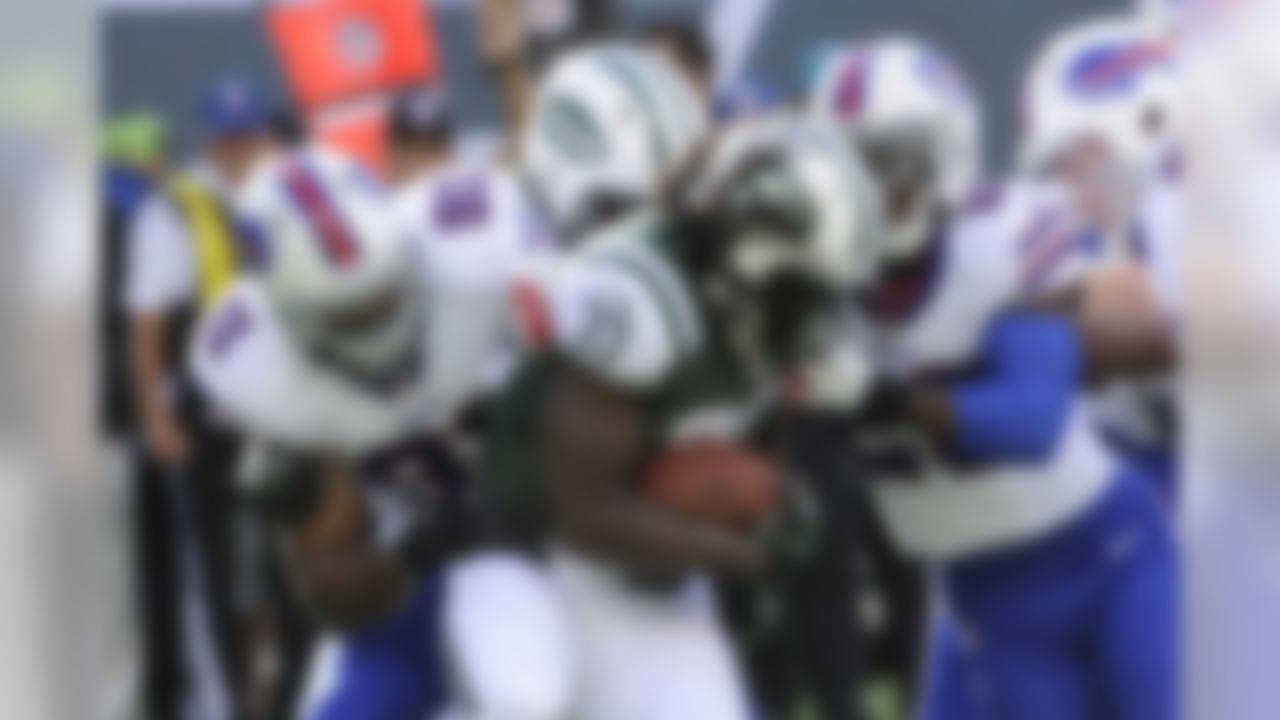 New York Jets' Chris Ivory (33) is tackled by Buffalo Bills' Manny Lawson (91) and Aaron Williams (23) during the first half of an NFL football game Sunday, Sept. 22, 2013, in East Rutherford, N.J. (AP Photo/Bill Kostroun)