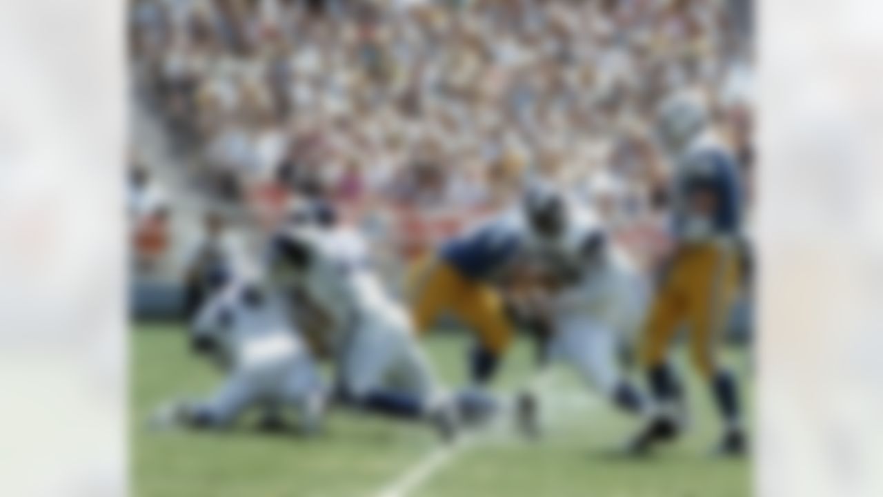 Los Angeles Rams Hall of Fame defensive linemen Merlin Olsen (74) and Deacon Jones (75) sack San Diego Chargers quarterback John Hadl (21) while defensive tackle Rosey Grier (76) also applies pressure with Chargers Hall of Fame tackle Tom Mix (74). (National Football League)