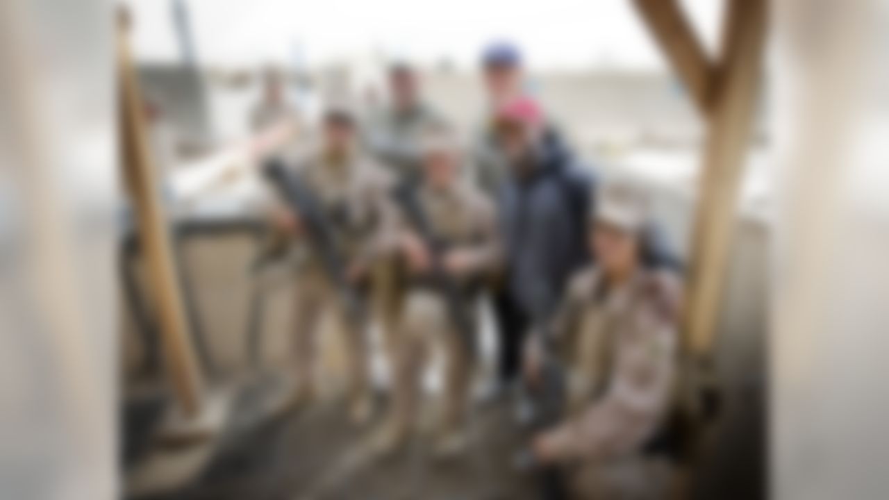 (L to R) Brandon Fields of the Miami Dolphins, Jimmy Graham of the New Orleans Saints and Pierre Garcon of the Washington Redskins make a special USO/NFL tour stop to the Combat Logistics Battalion in the Middle East and pose for a photo with troops on March 5, 2014.  These soldiers rarely get to join in on such celebrity visits while on-duty, so this visit definitely lifted their spirits brightened their day.  This trip marks the first USO experience for the trio. (USO Photo by Dave Gatley)