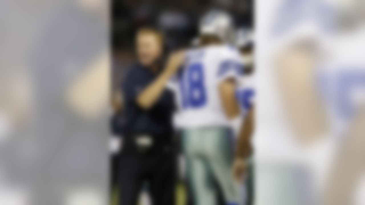 Dallas Cowboys coach Jason Garrett, left, celebrates with quarterback Kyle Orton (18) after Orton's 15-yard touchdown pass to Cole Beasley during the second quarter of an NFL preseason football game against the Oakland Raiders in Oakland, Calif., Friday, Aug. 9, 2013. (AP Photo/Marcio Jose Sanchez)
