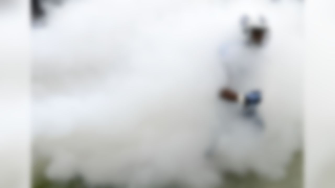 Tennessee Titans cornerback Blidi Wreh-Wilson runs through smoke as he is introduced before a game against the Jacksonville Jaguars. (AP Photo/Mark Zaleski)