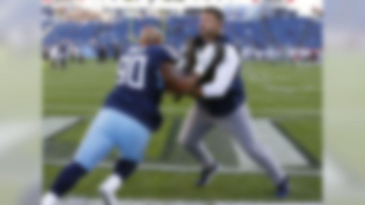 Tennessee Titans head coach Mike Vrabel helps Tennessee Titans defensive end DaQuan Jones (90) warm up before an NFL football game between the Titans and the New York Jets Sunday, Dec. 2, 2018, in Nashville, Tenn. (AP Photo/James Kenney)