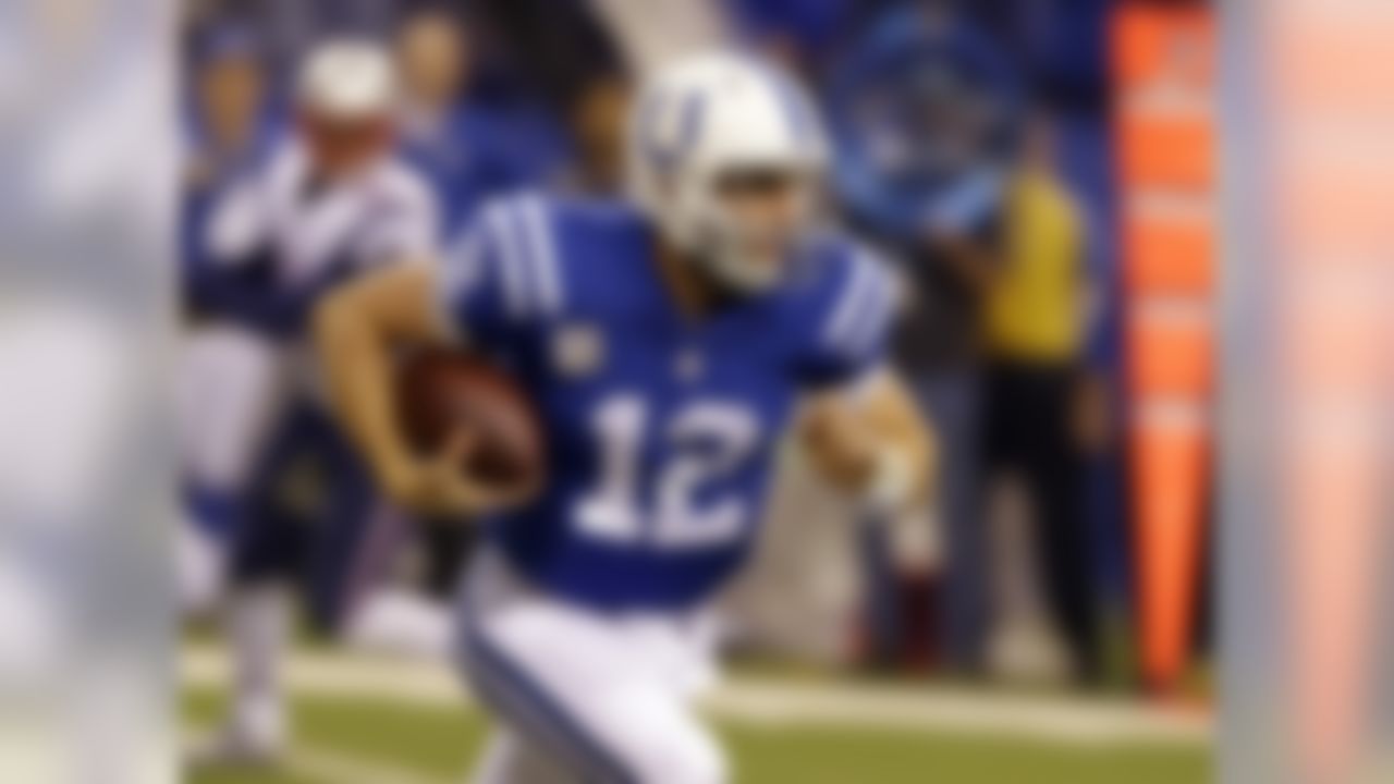 Indianapolis Colts quarterback Andrew Luck runs after being chased front he pocket by the New England Patriots during the first half of an NFL football game in Indianapolis, Sunday, Nov. 16, 2014. (AP Photo/Michael Conroy)