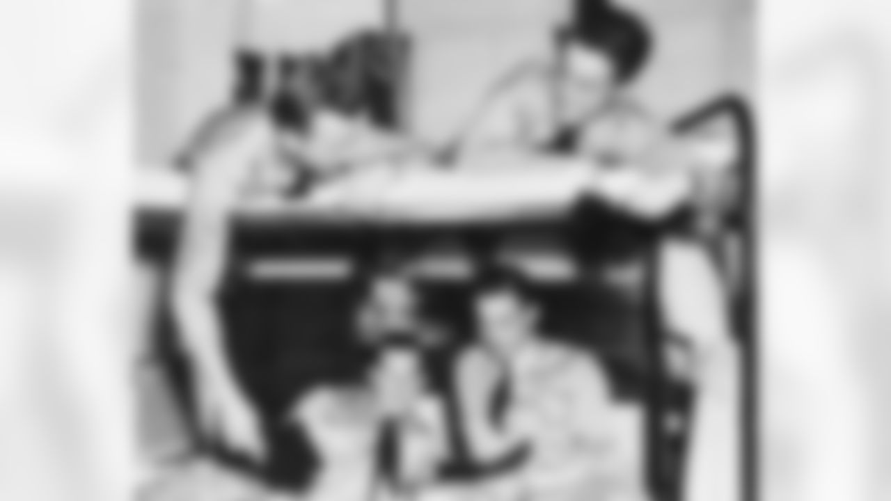 Relaxing during the eveing rest period at St. Mary's Pre-Flight School in Oakland, Calif., William Clay Ford (right, in lower bunk) compares pictures with his bunkmates, Cadets Robert Calhous (lower left), James Easton (upper left) and Bryce Eastburn, April 23, 1945. (Associated Press)