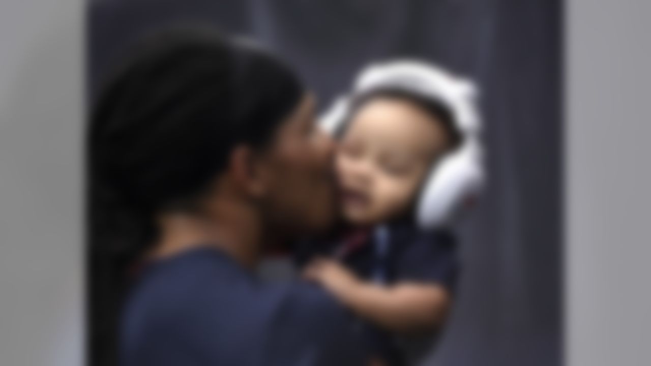 Houston Texans defensive back Andre Chachere, left, kisses his son Draden before an NFL preseason football game against the San Francisco 49ers Saturday, Aug. 18, 2018, in Houston. (AP Photo/Eric Christian Smith)