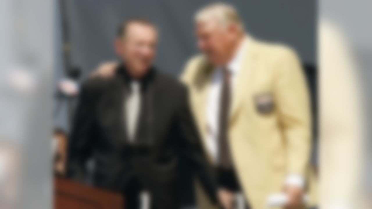 Former Oakland Raiders coach John Madden, right, puts his arm around Raiders owner Al Davis after Davis introduced Madden for enshrinement into the Pro Football Hall of Fame, Saturday, Aug. 5, 2006, in Canton, Ohio. (AP Photo/Mark Duncan)