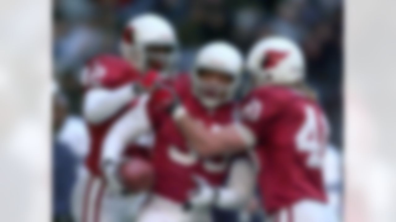 Arizona Cardinals cornerback Aeneas Williams (35) celebrates an interception with teammates Kwamie Lassiter (42) and Pat Tillman (40) against the Dallas Cowboy in the second quarter of the NFC wild card game in Irving, Texas, Saturday, Jan. 2, 1999. (AP Photo/David J. Phillip)