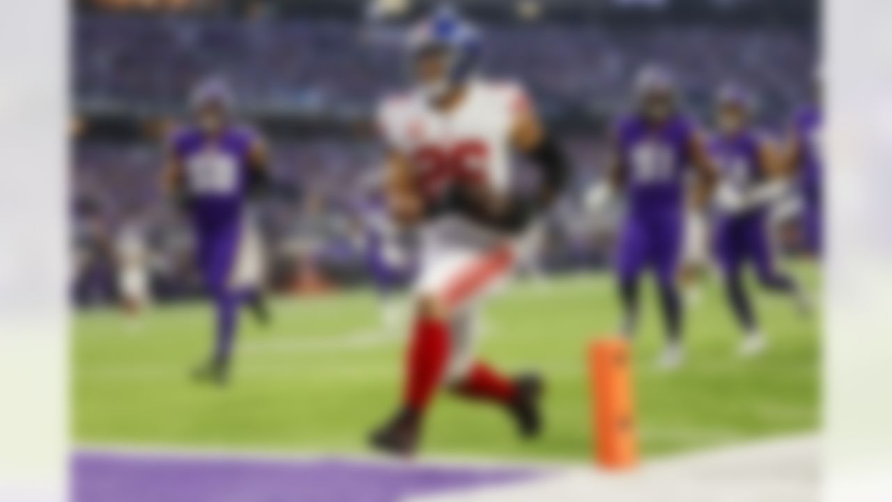 New York Giants running back Saquon Barkley (26) runs for a touchdown during an NFL Super Wild Card Weekend playoff game against the Minnesota Vikings on Sunday, January 15, 2023 in Minneapolis, Minnesota.