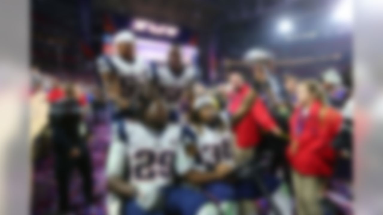 New England Patriots running backs LeGarrette Blount (29) and Brandon Bolden (38) and linebackers James Morris (52) and Darius Fleming (58) drive the Vince Lombardi Trophy around in a golf cart after defeating the Seattle Seahawks in Super Bowl XLIX at University of Phoenix Stadium on Sunday, February 1, 2015, in Glendale, AZ. (Steve Sanders/NFL)