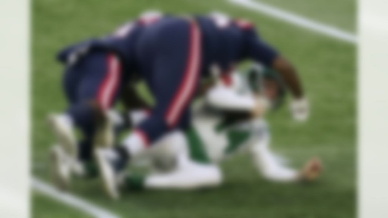 New England Patriots defensive lineman Adam Butler, top, sacks New York Jets quarterback Sam Darnold in the second half of an NFL football game, Sunday, Jan. 3, 2021, in Foxborough, Mass.
