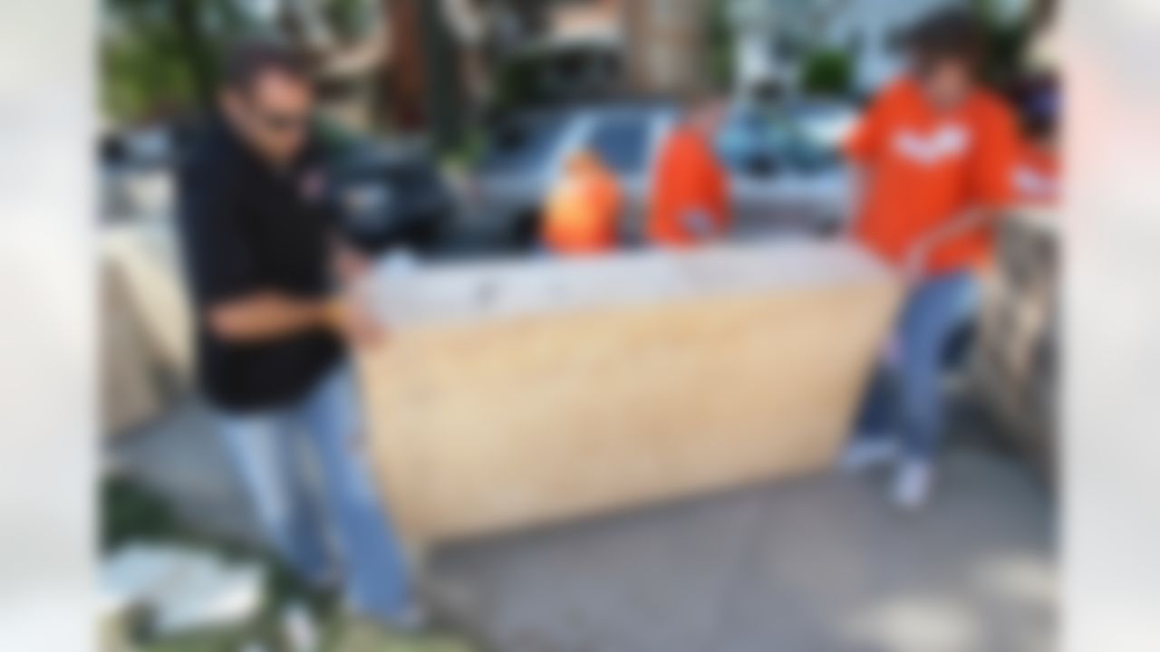 Mike Furrey and a Home Depot associate move one of the new bookshelf for Joy Preparatory Academy. (Photo by Tom Copeland/Home Depot)
