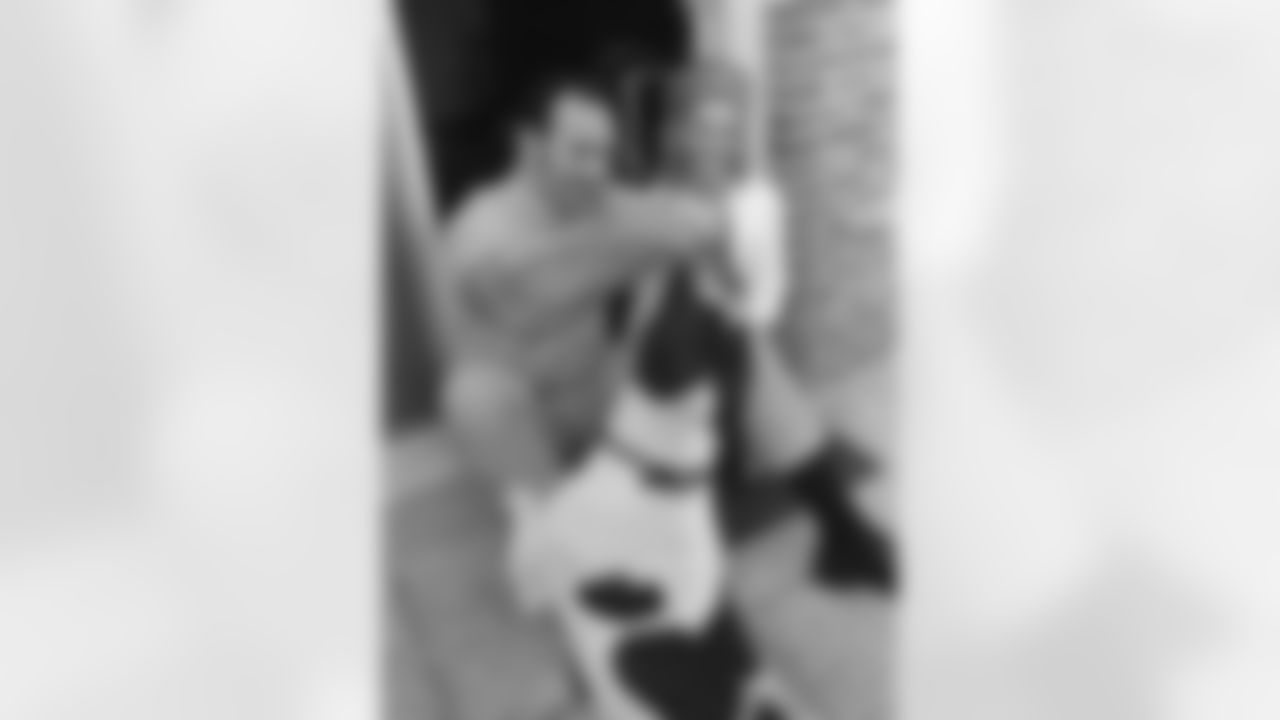 New Orleans Saints big defensive end Doug Atkins plays with his bulldog, Rebel, as he relaxes with his wife, Joyce, Dec. 20, 1969 in New Orleans, before the final game of his 17-year career in the National Football League. Atkins, who at 39 has tied the longevity record set by Lou Groza, plans to retire after the Saints-Pittsburgh Sunday. (Associated Press)