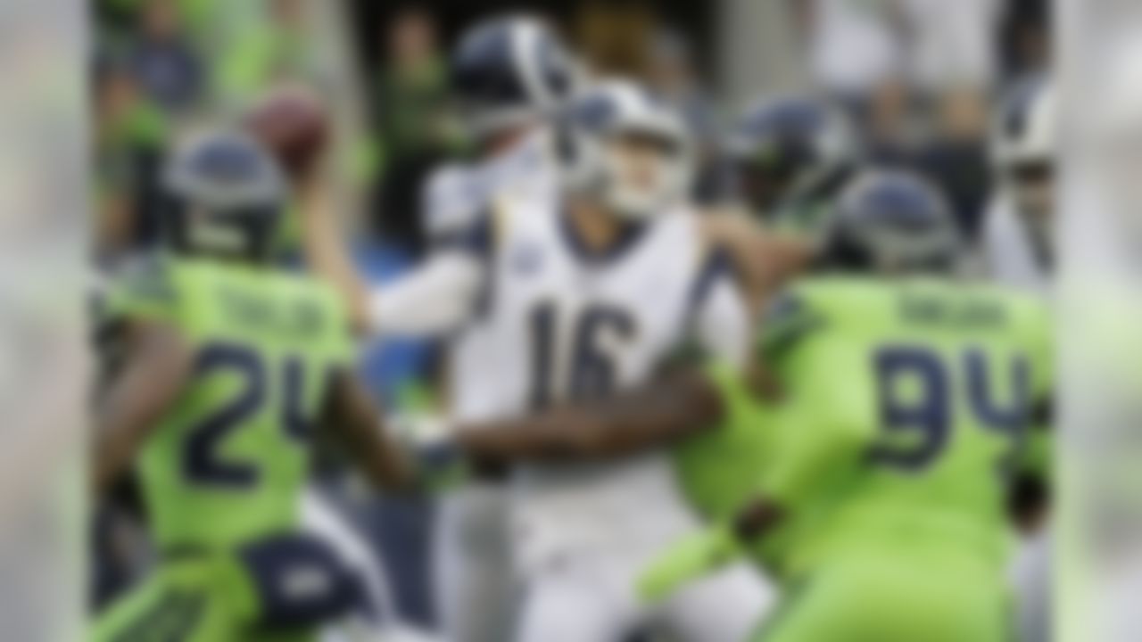 Los Angeles Rams quarterback Jared Goff, center, is tackled by Seattle Seahawks defensive tackle Quinton Jefferson, obscured, during the first half of an NFL football game Thursday, Oct. 3, 2019, in Seattle. ]