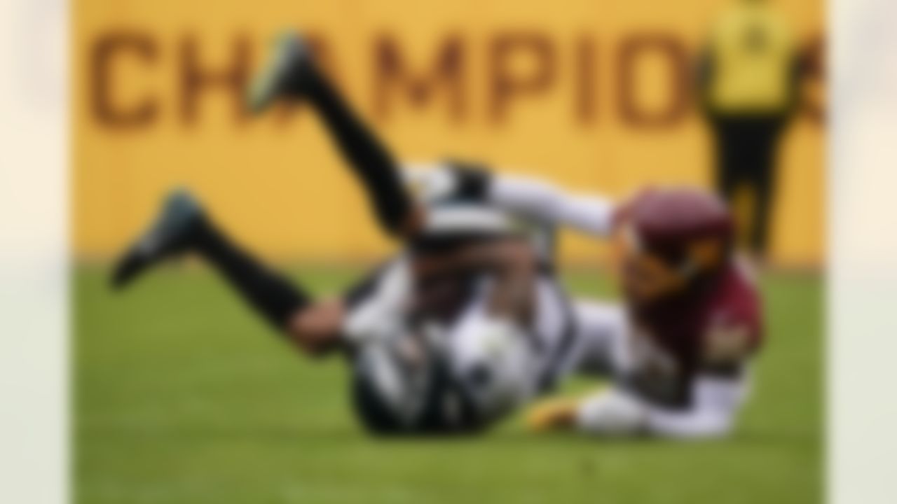 Philadelphia Eagles wide receiver DeVonta Smith (6) falls on the ground after making a catch Washington Football Team cornerback Danny Johnson (36) during the second half of an NFL football game, Sunday, Jan. 2, 2022, in Landover, Md.