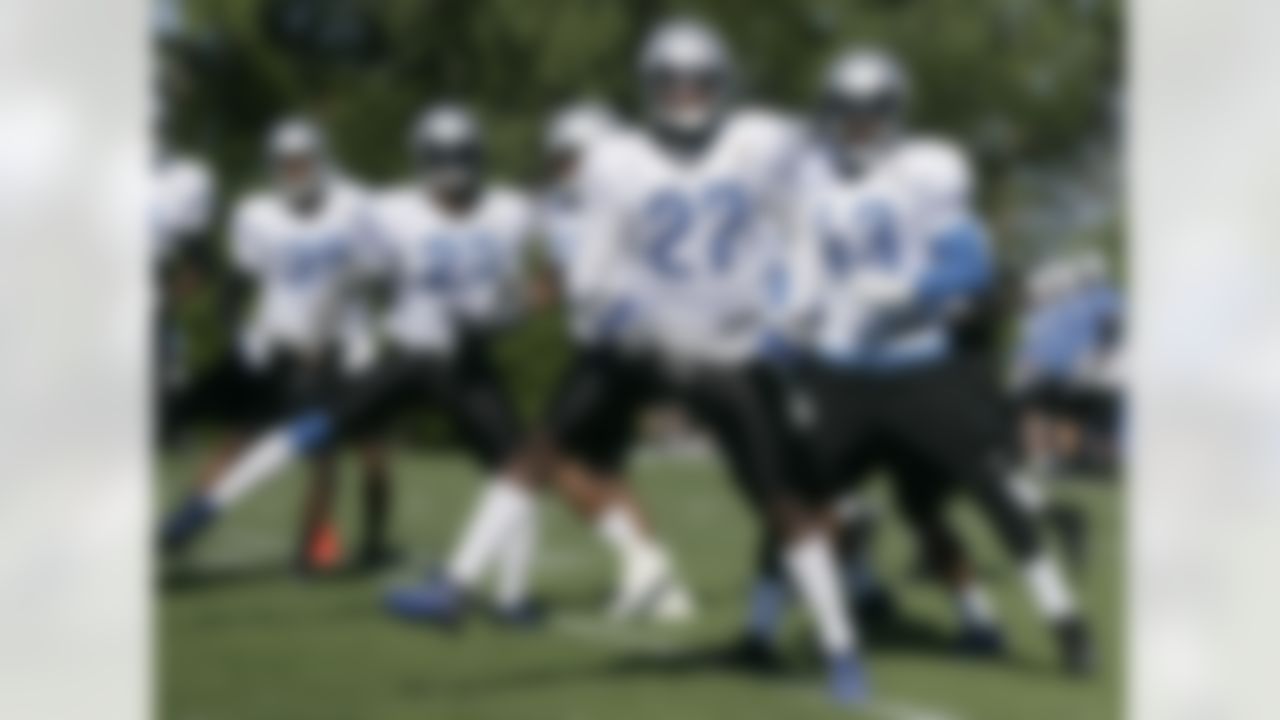 Detroit Lions' Ricardo Silva (39), Chris Houston (23), Alphonso Smith (27) and Justin Miller (43) run through an agility drill to begin the third day of their NFL football training camp Sunday, July 29, 2012, in Allen Park, Mich. (AP Photo/Duane Burleson)
