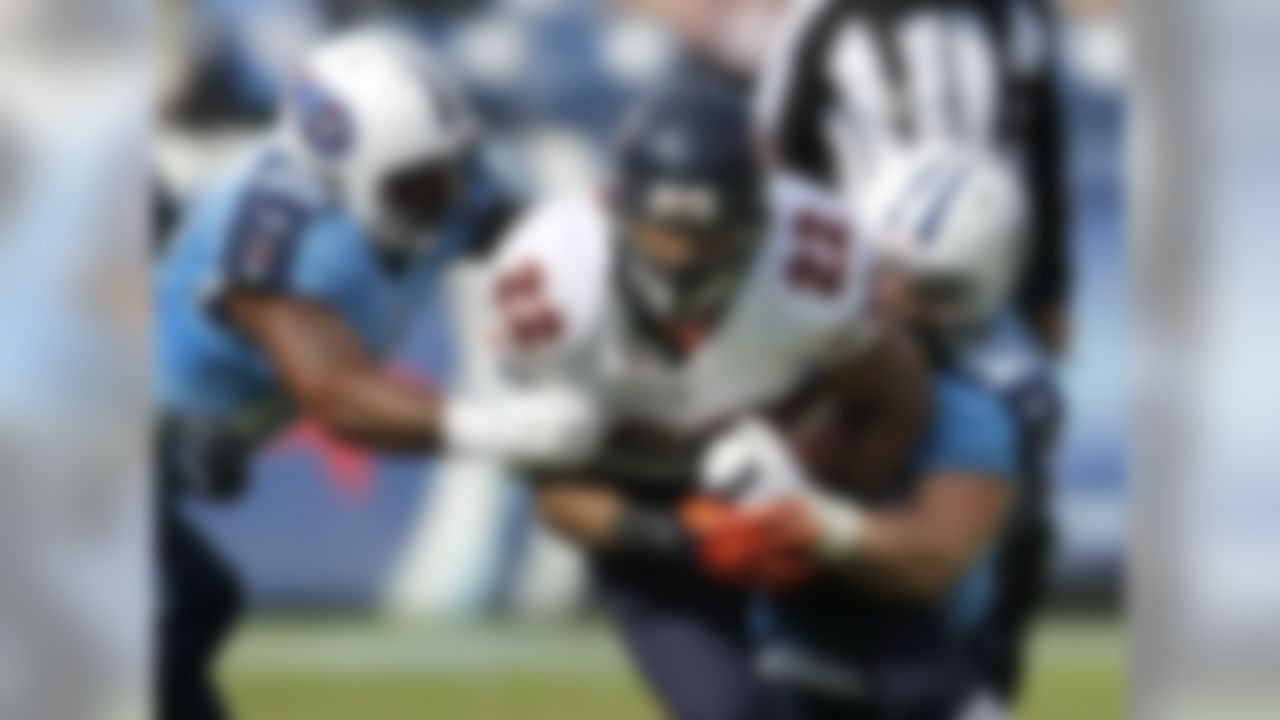 Chicago Bears running back Matt Forte (22) is stopped by Tennessee Titans defenders Jordan Babineaux (26) and Colin McCarthy (52) in the first quarter of an NFL football game on Sunday, Nov. 4, 2012, in Nashville, Tenn. (AP Photo/Joe Howell)