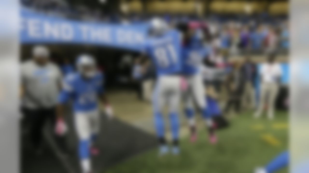 Detroit Lions wide receiver Calvin Johnson (81) greets defensive end Devin Taylor (98) during pre-game warmups of an NFL football game against the Arizona Cardinals, Sunday, Oct. 11, 2015, in Detroit. (AP Photo/Carlos Osorio)