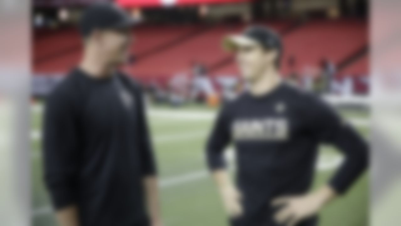 Atlanta Falcons quarterback Matt Ryan, left, speaks with New Orleans Saints quarterback Drew Brees before the first half of an NFL football game, Sunday, Jan. 1, 2017, in Atlanta. (AP Photo/David Goldman)