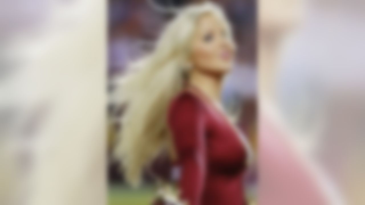 A Washington Redskins cheerleader dances on the field during a stoppage in play against the Seattle Seahawks in the NFC Wild Card playoff game at FedEx Field. The Seahawks won 24-14. (Geoff Burke/US Presswire)