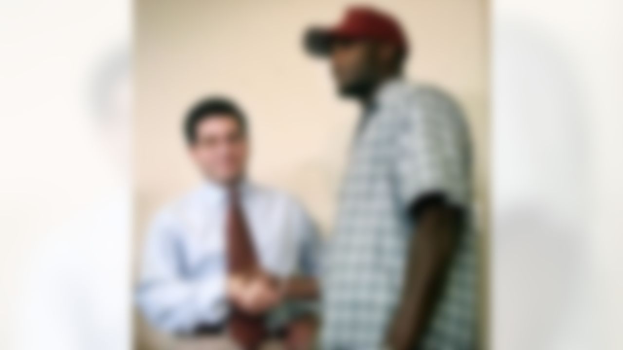 Washington Redskins owner Daniel Snyder, left, shakes hands with first-round draft pick Champ Bailey after announcing the signing of Bailey to a five-year, $9.64 million contact in Ashurn, Va. Saturday July 24, 1999. (AP Photo/Pablo Martinez Monsivais)