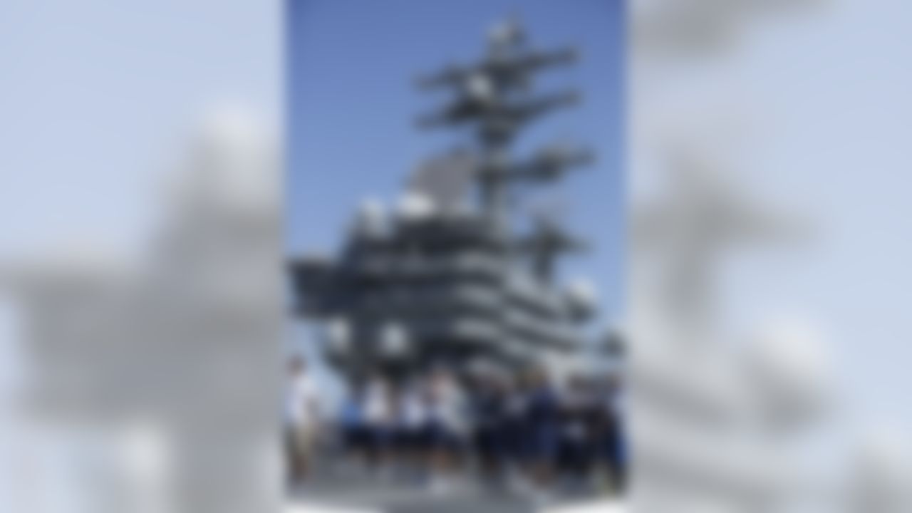 The San Diego Chargers gather during a NFL football training on the flight deck of the USS Ronald Reagan aircraft carrier Wednesday, Aug. 28, 2013, in Coronado, Calif. The Chargers play their final preseason game Thursday against the San Francisco 49ers. (AP Photo/Gregory Bull)