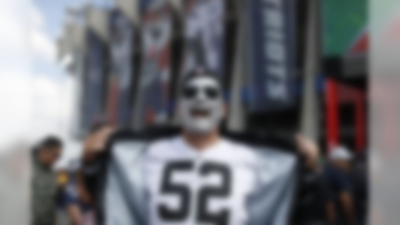 An Oakland Raiders fan poses for a photo in front of Azteca Stadium prior to an NFL fotball game against the New England Patriots, Sunday, Nov. 19, 2017, in Mexico City. (AP Photo/Dario Lopez-Mills)