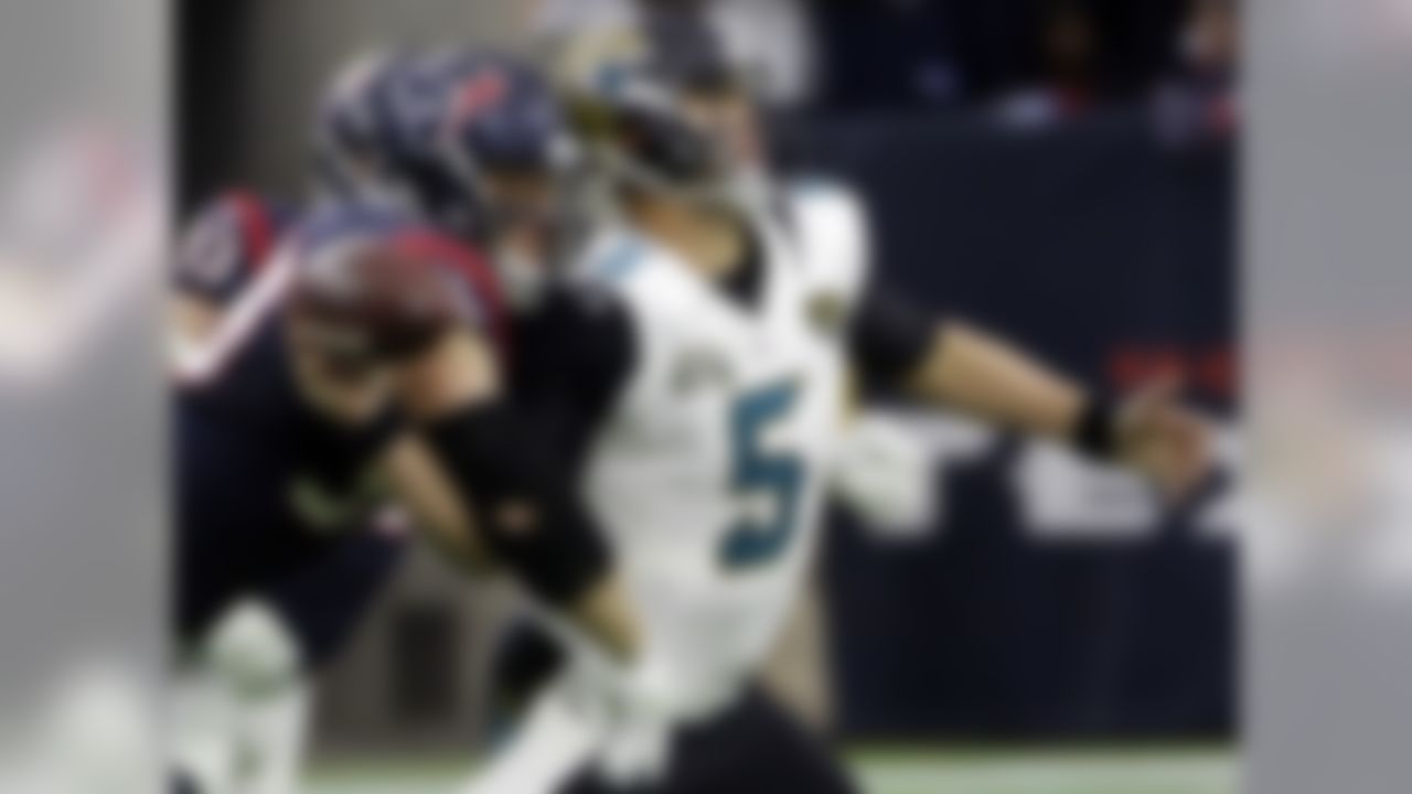 Houston Texans defensive end J.J. Watt (99) causes Jacksonville Jaguars quarterback Blake Bortles (5) to fumble the ball during the first half of an NFL football game Sunday, Dec. 28, 2014, in Houston. (AP Photo/David J. Phillip)