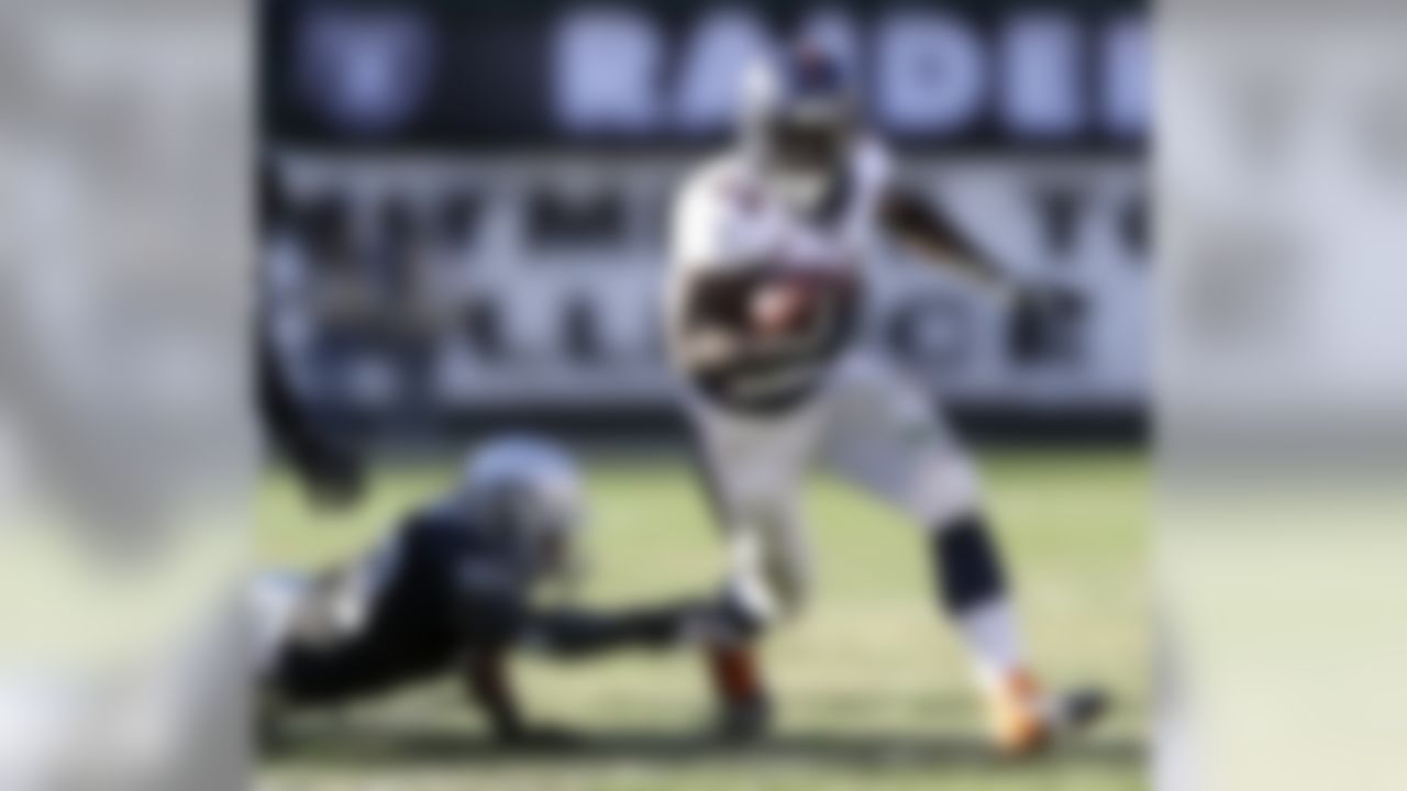 Denver Broncos running back Montee Ball (28) runs past Oakland Raiders linebacker Nick Roach (53) during the second quarter of an NFL football game, Sunday, Dec. 29, 2013, in Oakland, Calif. (AP Photo/Marcio Jose Sanchez)