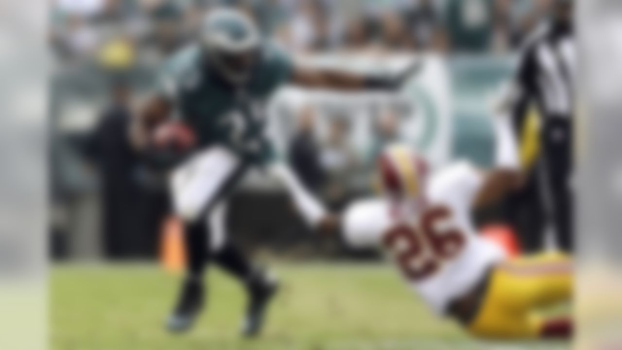 Philadelphia Eagles' LeSean McCoy (25)is dragged to the turf by Washington Redskins cornerback Josh Wilson during the first half of an NFL football game in Philadelphia, Sunday, Nov. 17, 2013. (AP Photo/Matt Rourke)