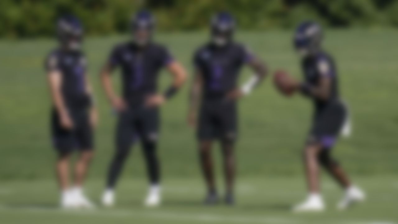 Baltimore Ravens quarterbacks, from left, Trace McSorley, Jordan Ta'amu, and Tyler Huntley watch as Lamar Jackson works out during the team's NFL football training, Tuesday, June 15, 2021, in Owings Mills, Md.