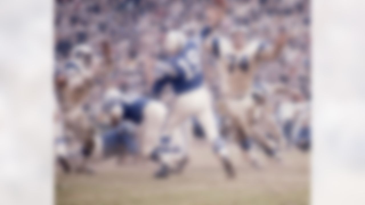 Hall of Fame quarterback Johnny Unitas (19) of the Baltimore Colts throws a pass under pressure from Hall of Fame Rams defensive tackle Merlin Olsen (74) during the a 28 to 24 Colts victory over the Los Angeles Rams on Dec. 15, 1968 at the Los Angeles Memorial Coliseum in Los Angeles. (National Football League)