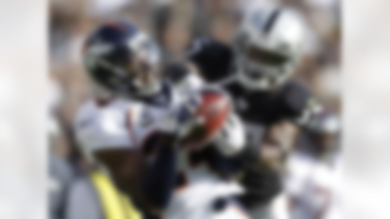 Denver Broncos cornerback Champ Bailey (24) intercepts a pass intended for Oakland Raiders wide receiver Denarius Moore (17) in the second quarter of an NFL football game in Oakland, Calif., Sunday, Nov. 6, 2011. The Broncos won 38-24. (AP Photo/Ben Margot)