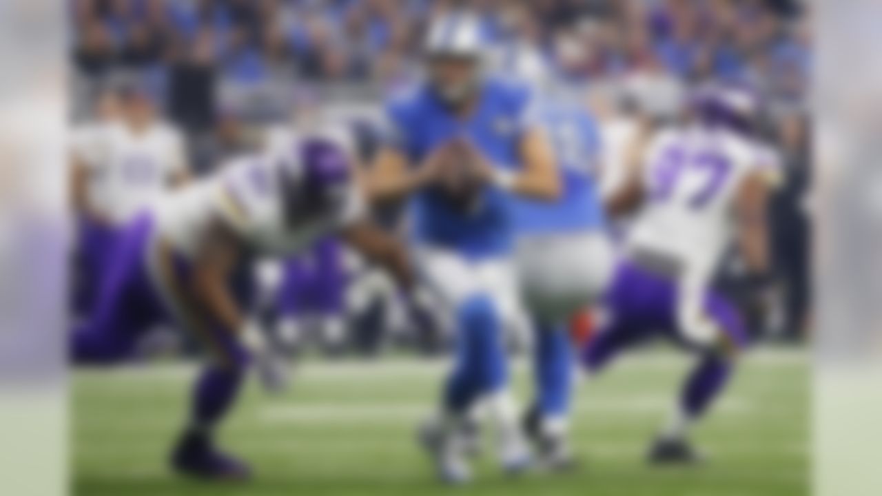 Detroit Lions quarterback Matthew Stafford (9) scrambles away from Minnesota Vikings defensive tackle Tom Johnson (92) during the first half of an NFL football game, Thursday, Nov. 24, 2016, in Detroit. (AP Photo/Rick Osentoski)