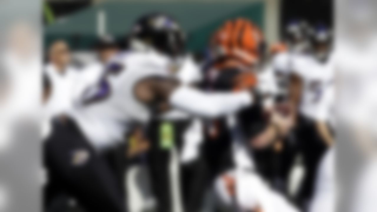 Baltimore Ravens outside linebacker Terrell Suggs, left, sacks Cincinnati Bengals quarterback Andy Dalton during the first half of an NFL football game in Cincinnati, Sunday, Oct. 26, 2014. (AP Photo/Al Behrman)