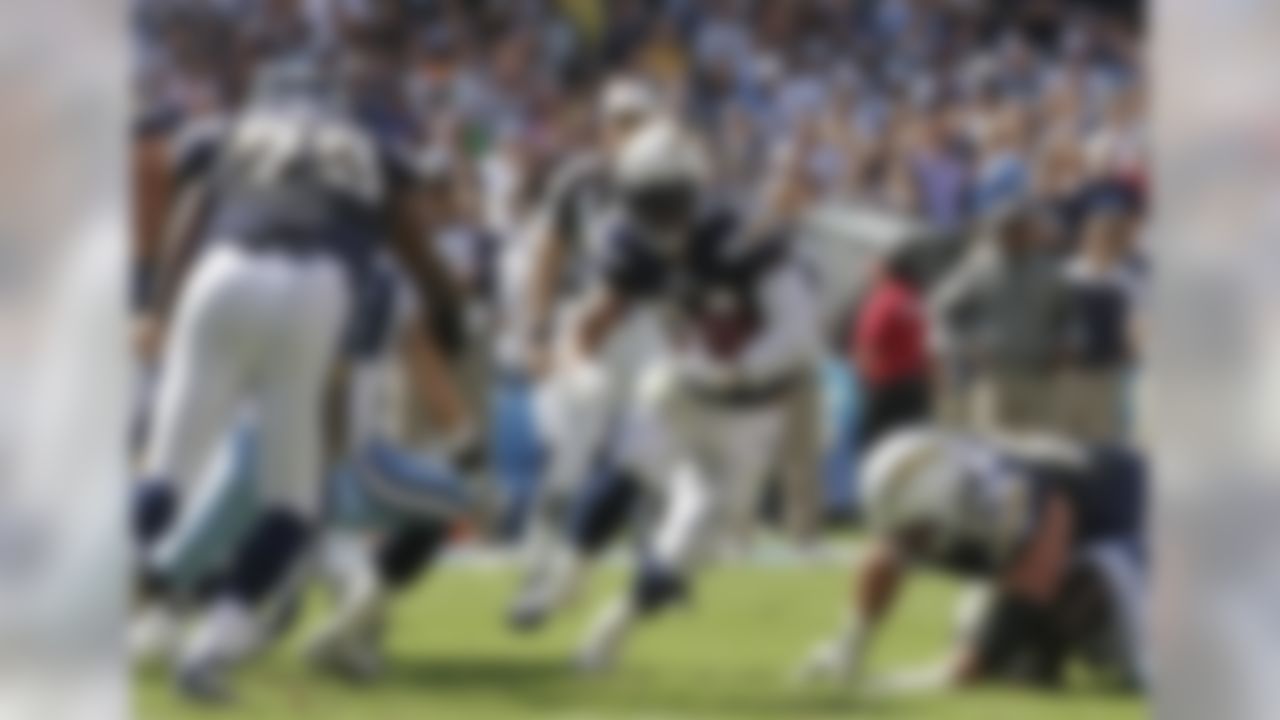 San Diego Chargers running back Ryan Mathews, center, finds a hole in the Tennessee Titans defense while running for a five-yard gain during the first half of an NFL football game on Sunday, Oct. 31, 2010, in San Diego. (AP Photo/Gregory Bull)