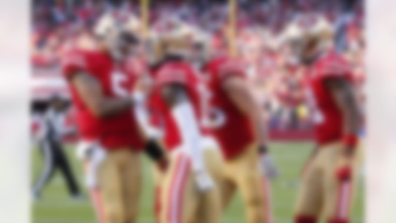 San Francisco 49ers quarterback Trey Lance, left, celebrates after throwing a touchdown pass to Deebo Samuel, middle, during the second half of an NFL football game against the Houston Texans in Santa Clara, Calif., Sunday, Jan. 2, 2022.