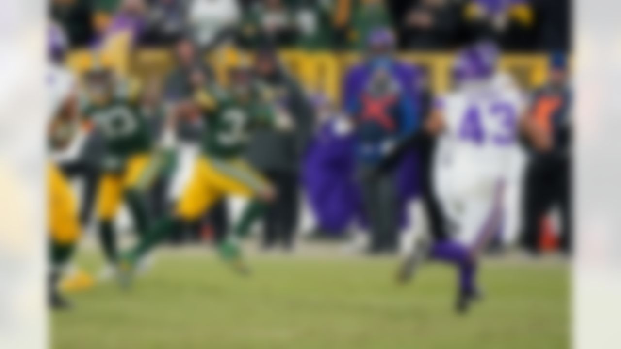 Green Bay Packers running back Aaron Jones (33) runs the ball during an NFL football game against the Minnesota Vikings on Sunday, January 2, 2022 in Green Bay, Wisconsin.