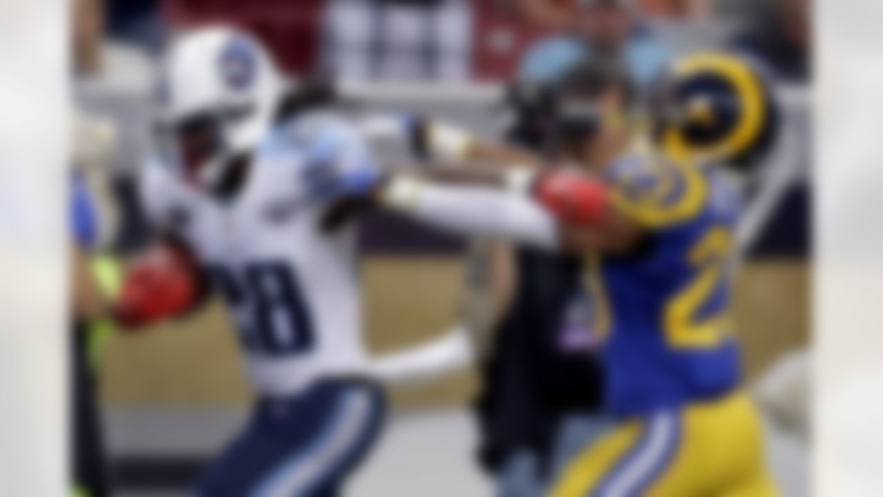 Tennessee Titans running back Chris Johnson (28) scores on a 19-yard run past St. Louis Rams safety Rodney McLeod (23) during the fourth quarter of an NFL football game Sunday, Nov. 3, 2013, in St. Louis. (AP Photo/Jeff Roberson)