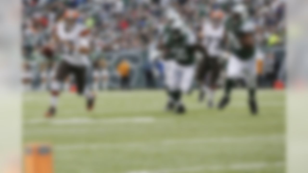 Cleveland Browns quarterback Jason Campbell (17) scrambles away from New York Jets' DeMario Davis (56) and Leger Douzable (78) during the first half of an NFL football game on Sunday, Dec. 22, 2013, in East Rutherford, N.J.  (AP Photo/Kathy Willens)