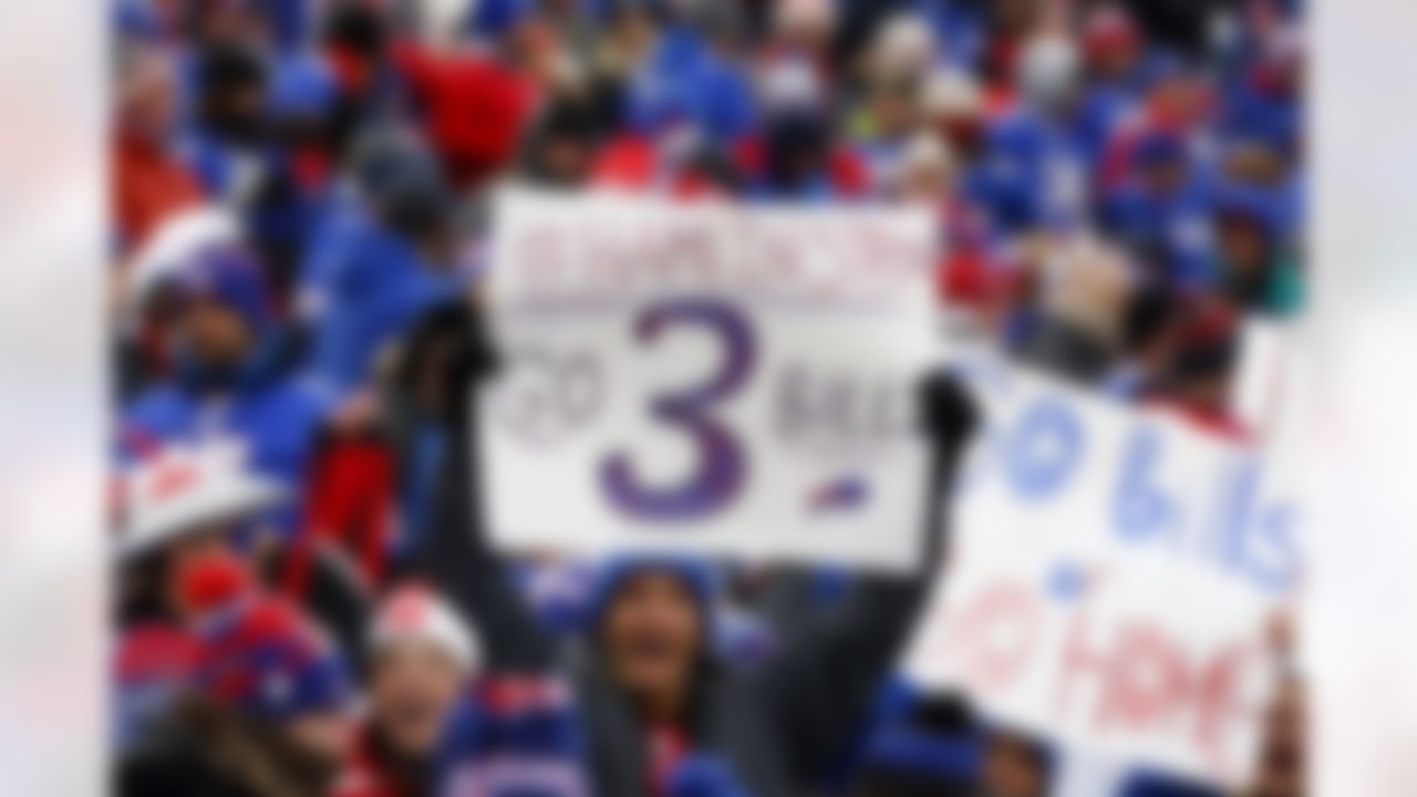 Fans hold signs in support of safety Damar Hamlin before an NFL football game against the New England Patriots, Sunday, Jan. 8, 2023, in Orchard Park, N.Y. Hamlin remains hospitalized after suffering a catastrophic on-field collapse in the team's previous game against the Cincinnati Bengals.