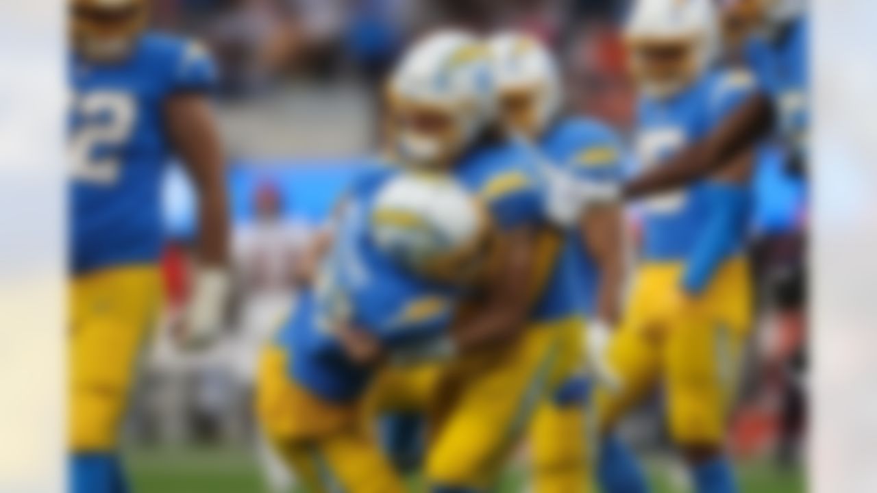 Los Angeles Chargers quarterback Justin Herbert (10) and wide receiver Mike Williams (81) celebrate a touchdown during an NFL football game against the Denver Broncos on Sunday, January 2, 2022 in Inglewood, California.