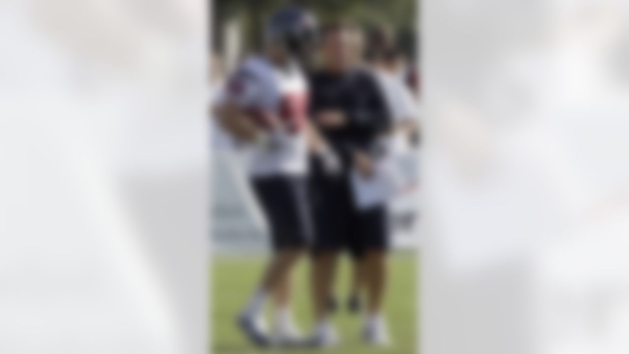 Houston Texans coach Gary Kubiak, right, talks with tight end Garrett Graham (88) during the team's first NFL training camp practice of the season Friday, July 30, 2010,  in Houston. (AP Photo/David J. Phillip)
