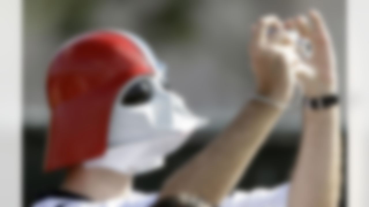 Houston Texans fan John Black takes a picture  during a NFL football training camp practice Saturday, July 31, 2010 in Houston. (AP Photo/David J. Phillip)