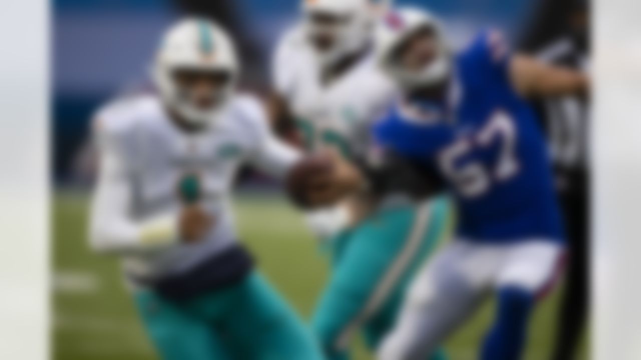 Miami Dolphins quarterback Tua Tagovailoa (1) runs with the ball against the Buffalo Bills during the third quarter of an NFL football game, Sunday, Jan. 3, 2021, in Orchard Park, N.Y.