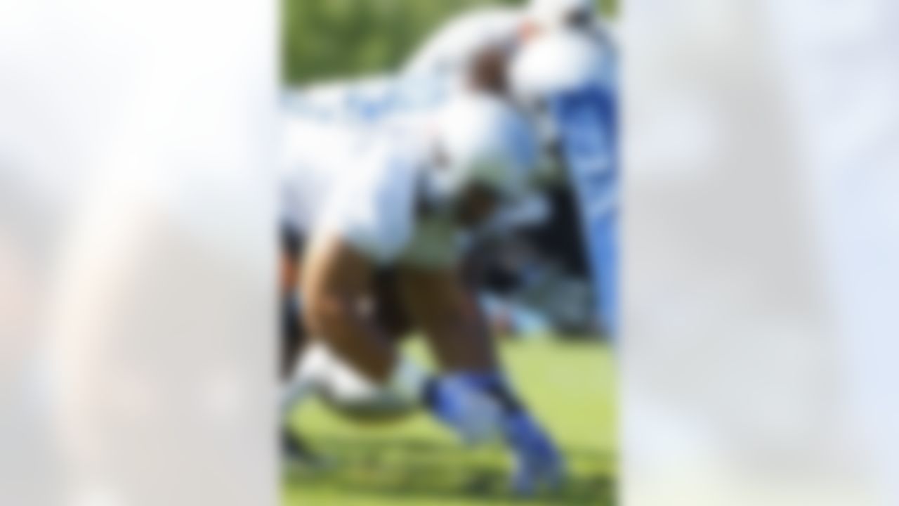 Detroit Lions defensive tackle Ndamukong Suh (90) lines up for a drill during NFL football training camp at the team's practice facility in Allen Park, Mich., Saturday, July 30, 2011. (AP Photo/Rick Osentoski)