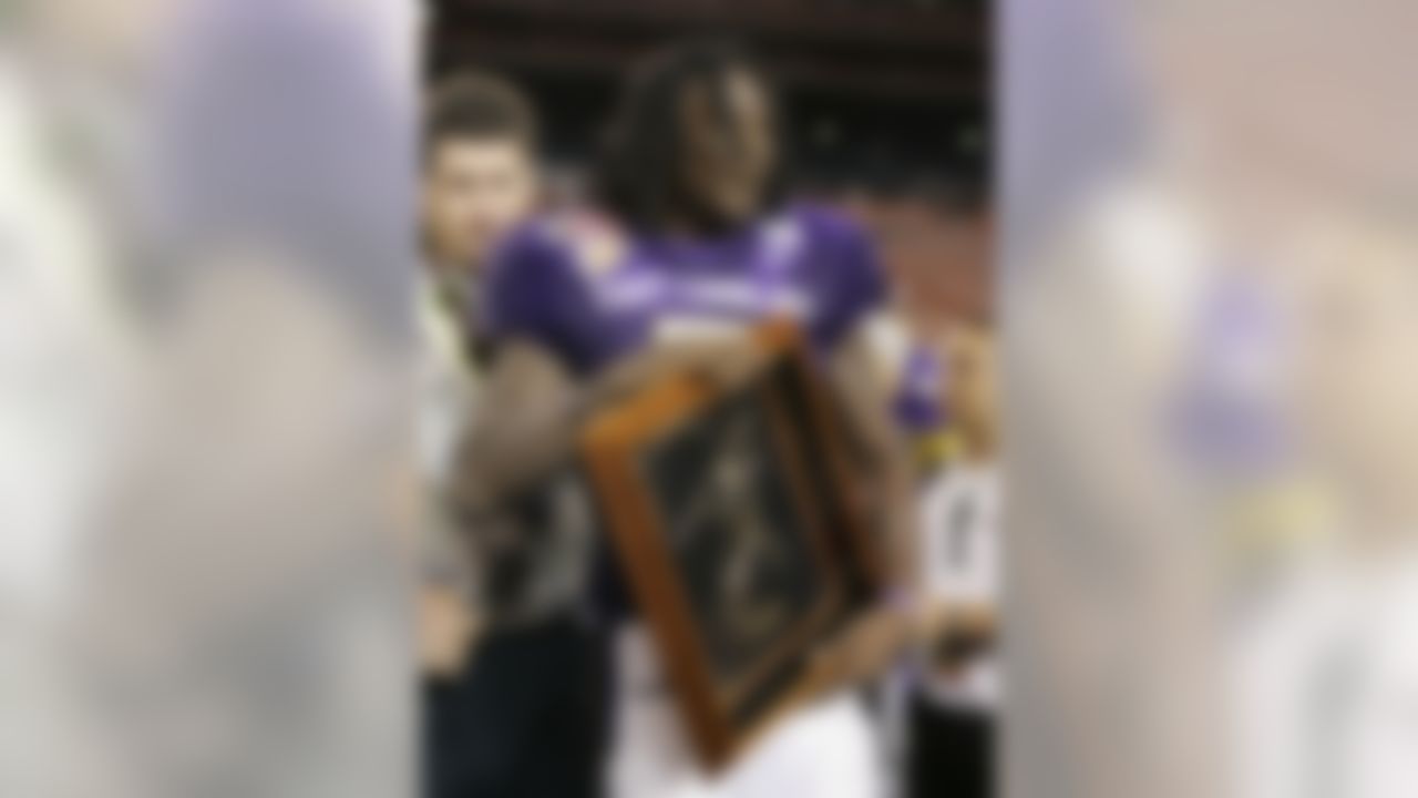 East Carolina running back Chris Johnson holds the MVP award after his team defeated Boise State 41-38 to win the Hawaii Bowl football game at Aloha Stadium on Sunday, Dec. 23, 2007, in Honolulu. (AP Photo/Marco Garcia)